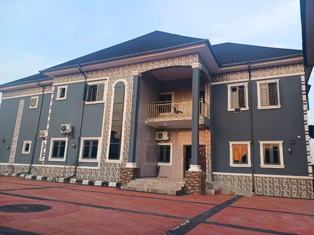 a large building with a balcony on a street at J-D Suites in Ozuoba