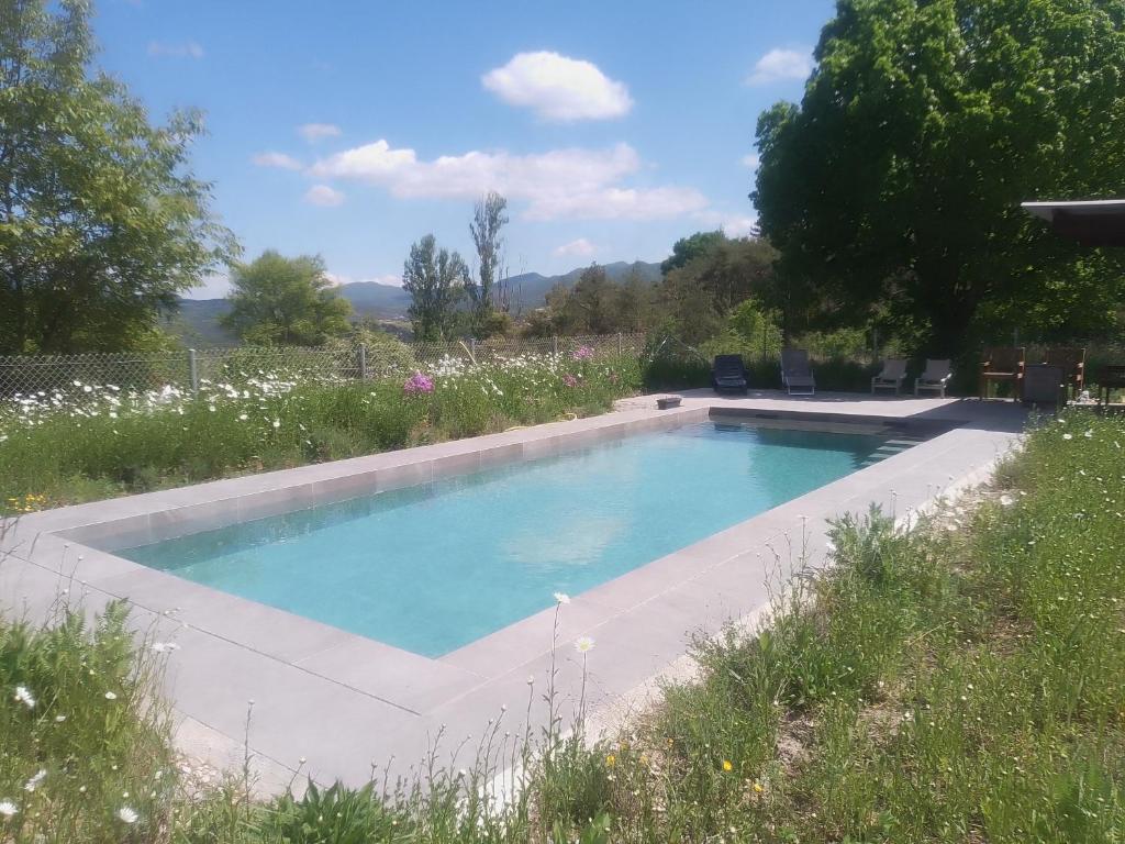 a swimming pool in a yard with a garden at La vie en Rosans - The upperhouse in Saint-André-de-Rosans