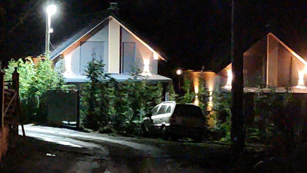 a car parked in front of a house at night at Villa Ensari Jezerc in Ferizaj