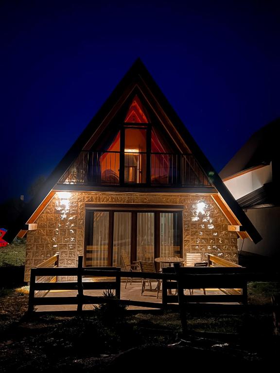 a house at night with a bench in front of it at Guest House Sara 2 in Žabljak