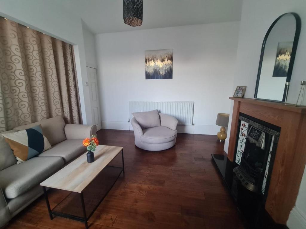 a living room with a couch and a table at Lovely four bed Roker house in Sunderland