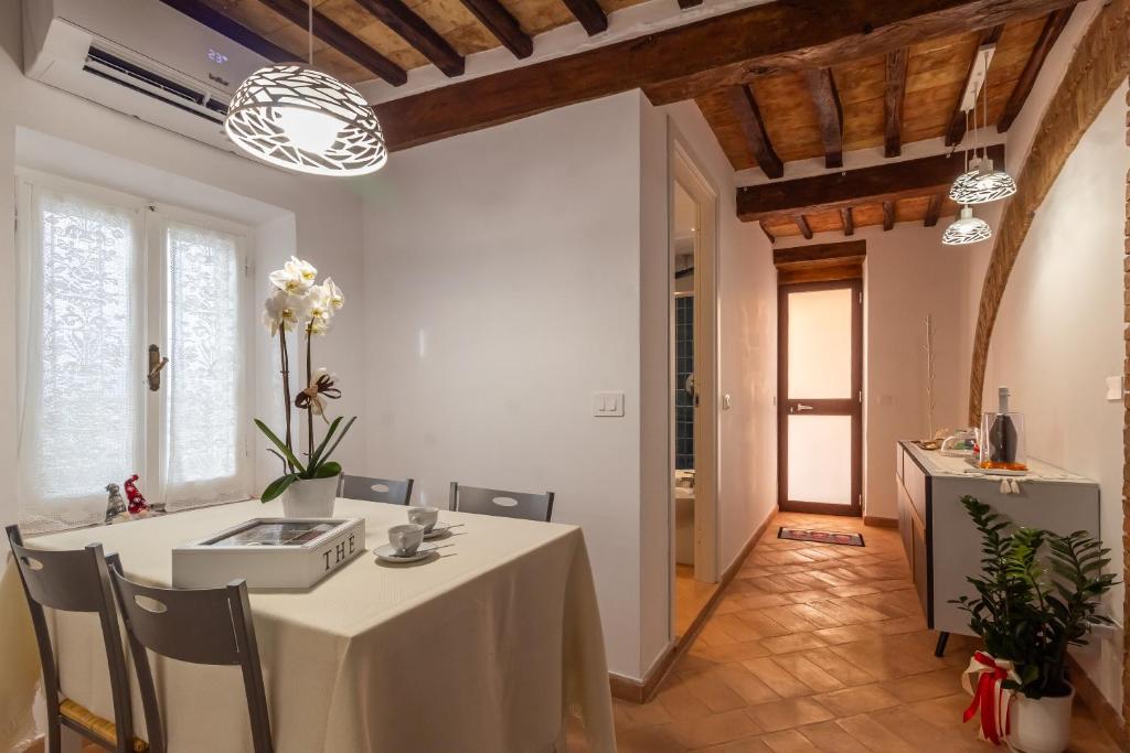 ein Esszimmer mit einem weißen Tisch und Stühlen in der Unterkunft La casetta dell'amore di Mimmi in Castel Viscardo