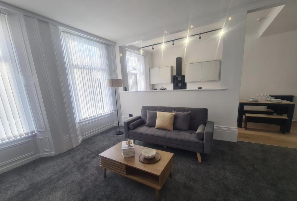 a living room with a couch and a coffee table at Modern one bed close to city in Sunderland