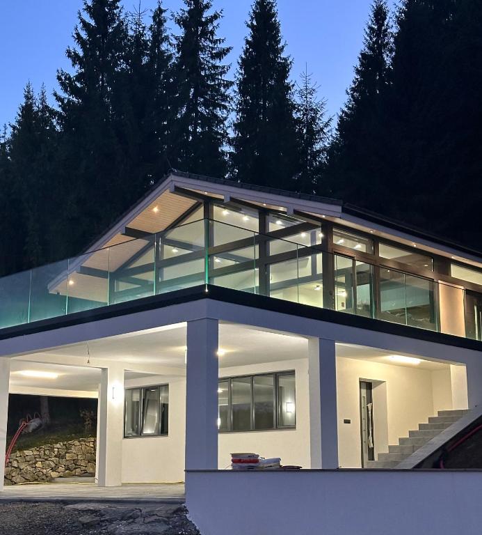 a large house with glass windows on top of it at Berryhouse in Vyshkiv