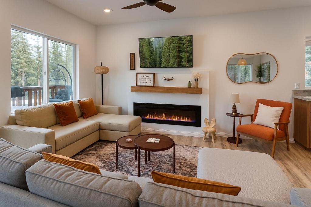 a living room with a couch and a fireplace at Brand New Cabin with Fire Pit & Outdoor Projector in Duck Creek Village