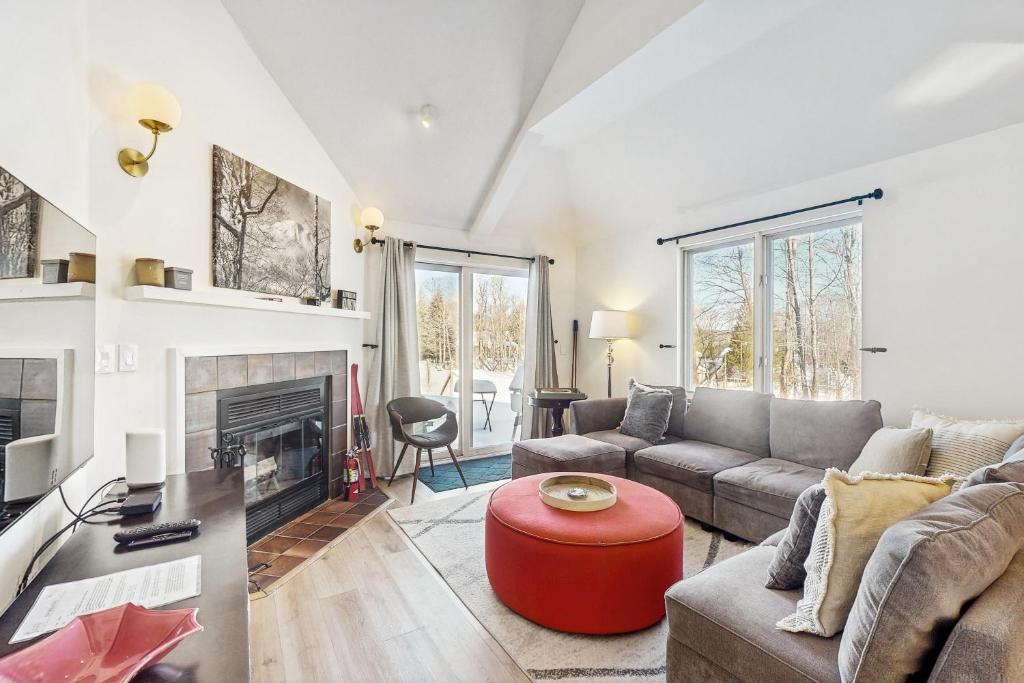 a living room with a couch and a fireplace at The Woods Village 1 in Killington
