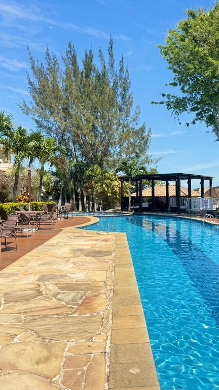 a swimming pool at a resort with blue water at Casa GERIBÁ in Búzios