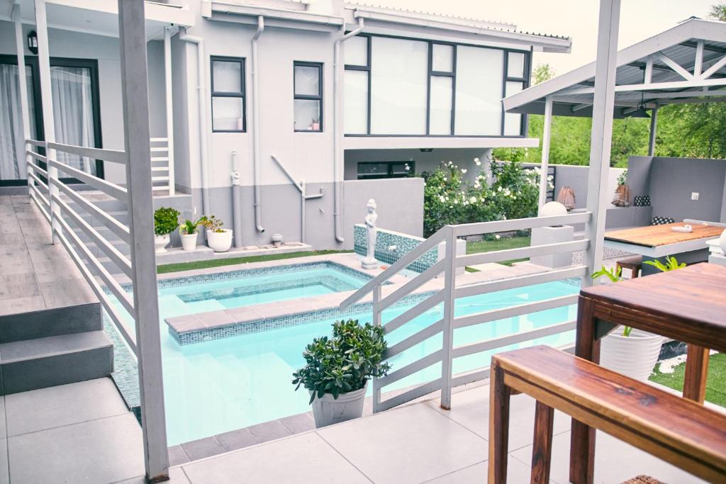 a balcony with a swimming pool on a house at WINDHOEK ODYSSEY House in Windhoek