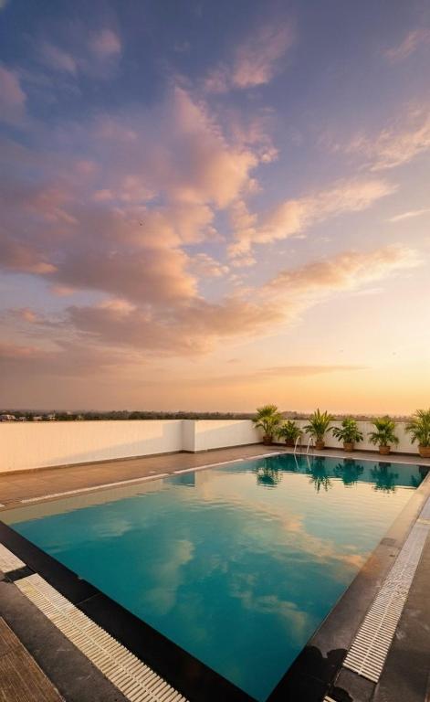 a swimming pool on top of a building at BOHO Living Kochi Airport in Cochin