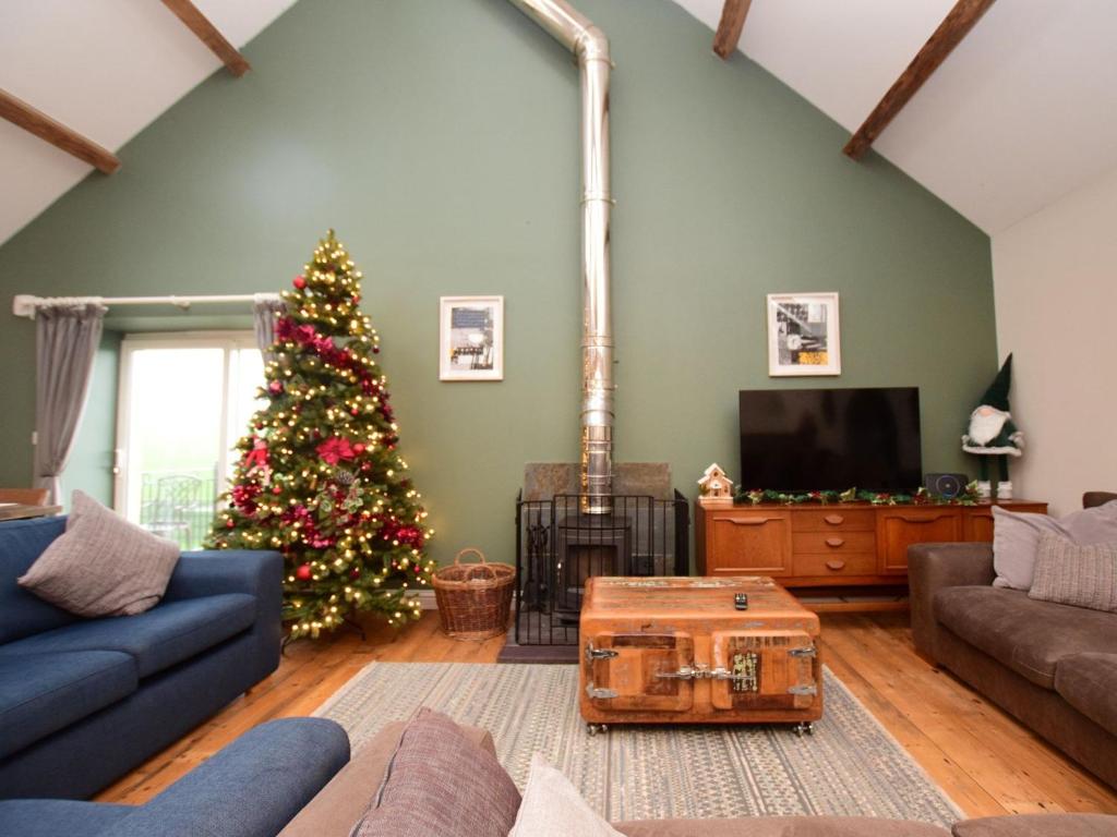 a living room with a christmas tree and a couch at 5 Bed in Botwnnog 55385 in Bottwnog
