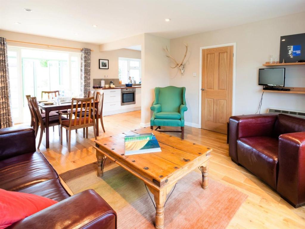 a living room with a couch and a table at 3 Bed in Brancaster Staithe oc-kt150 in Brancaster