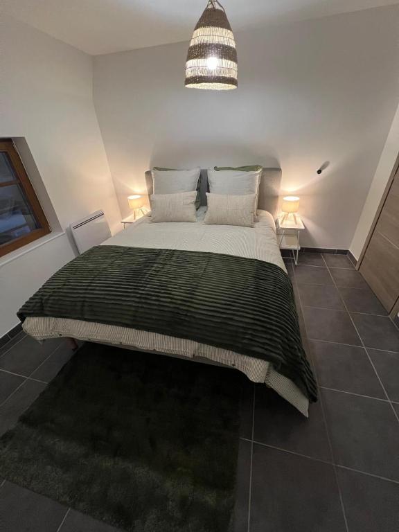 a bedroom with a large bed with two pillows at Sand & Chill - Appartement 65R in Rouffach