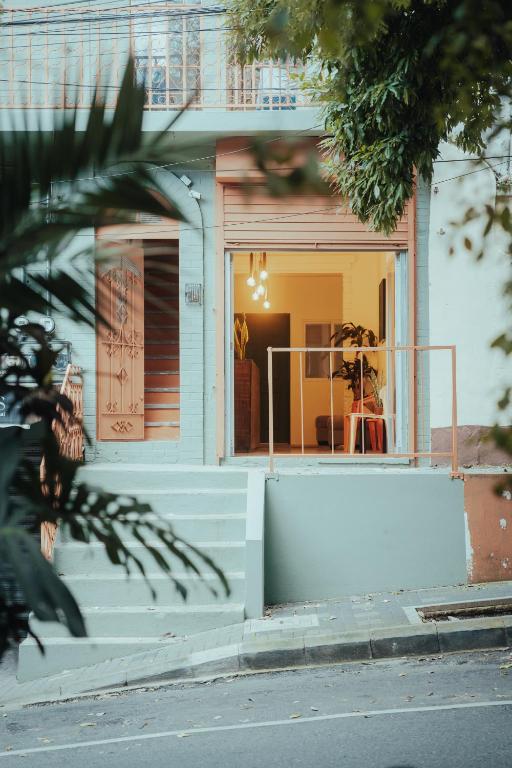a house with a white wall in front of it at Central Hostel Zona 4 in Guatemala