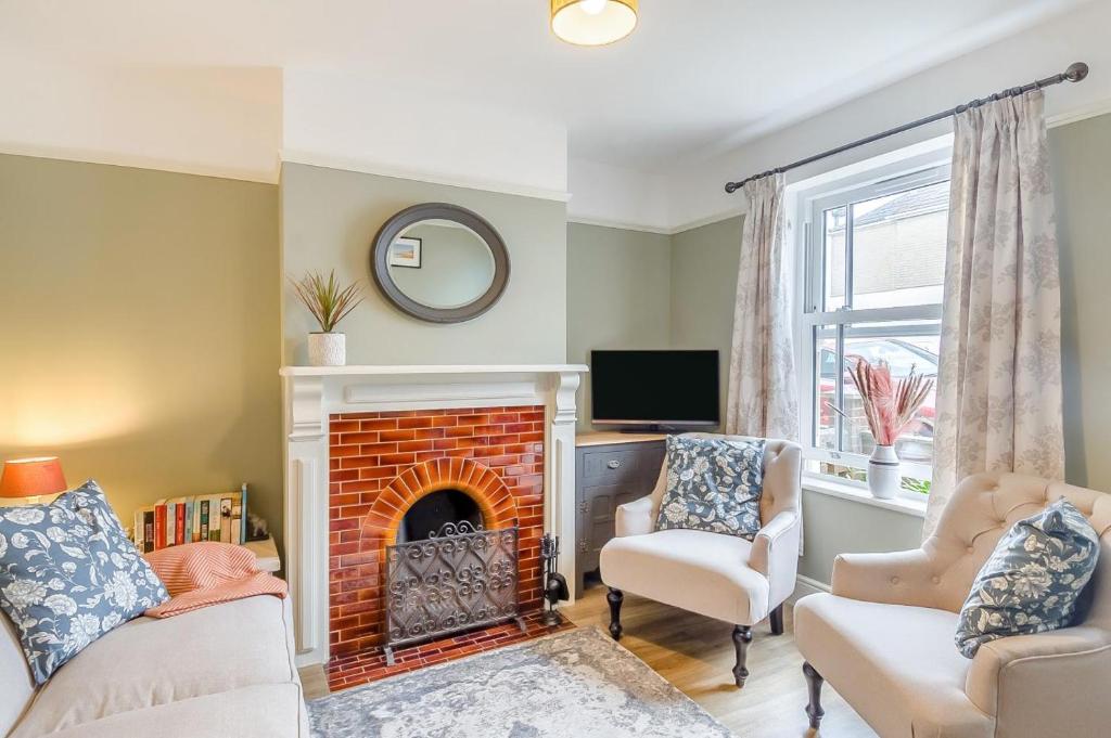 a living room with two chairs and a fireplace at 2 Bed in Pakefield oc-p32922 in Lowestoft