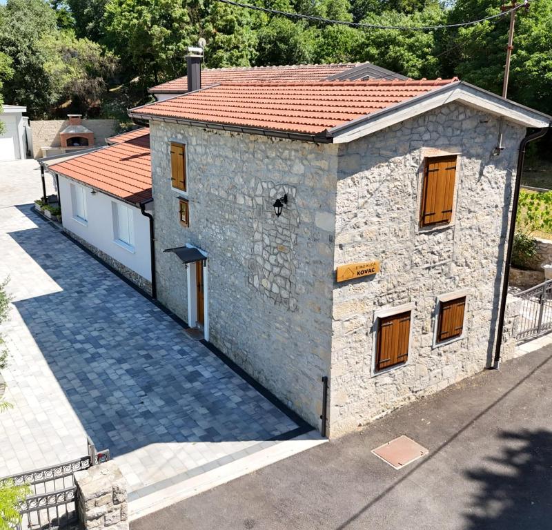 a small stone building with a red roof at CASA Kovac in Ljubuški