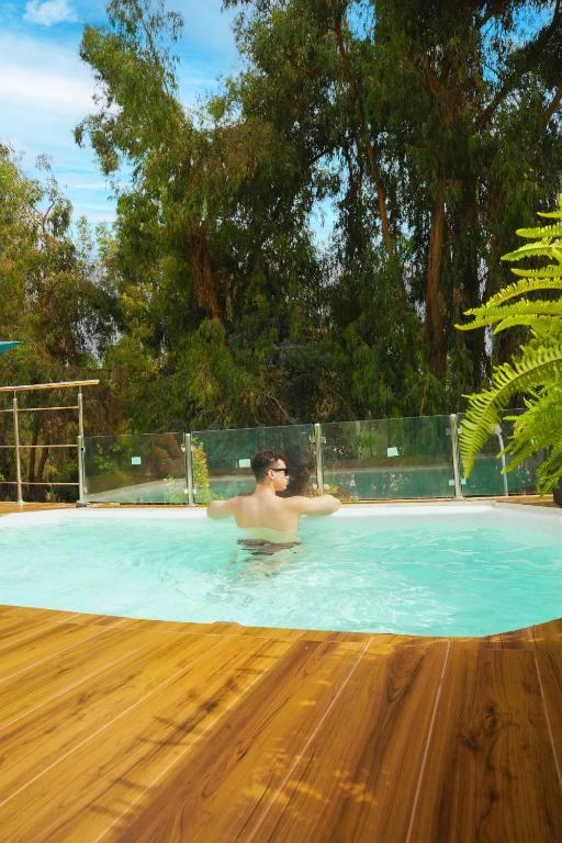 a man is in a swimming pool at HC Gatsby Hoteles in Arequipa