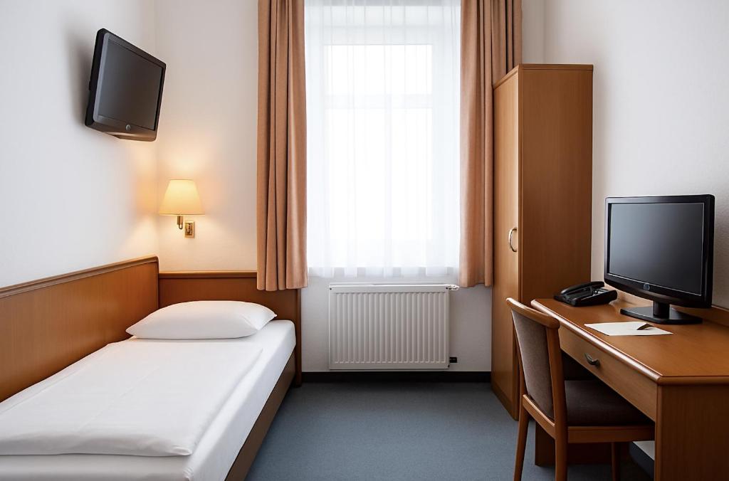 Una televisión o centro de entretenimiento en Hotel Villa Noel am Hauptbahnhof