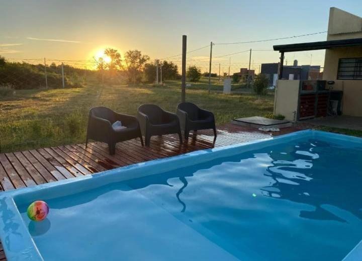 a group of chairs sitting next to a swimming pool at Villa del Sol Complejo in Liebig