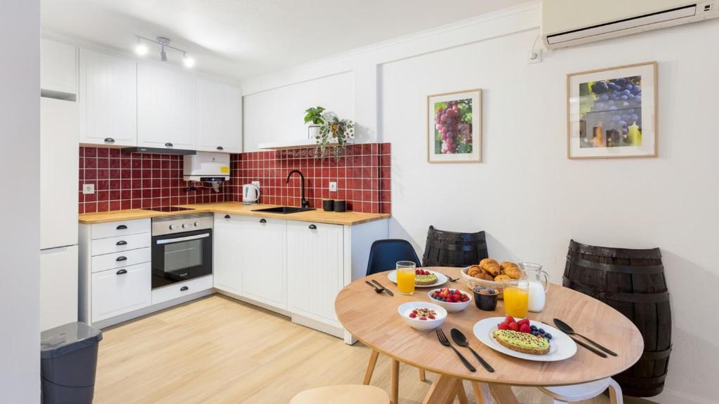 a kitchen with a wooden table with food on it at Casa da Se Cottage in Silves