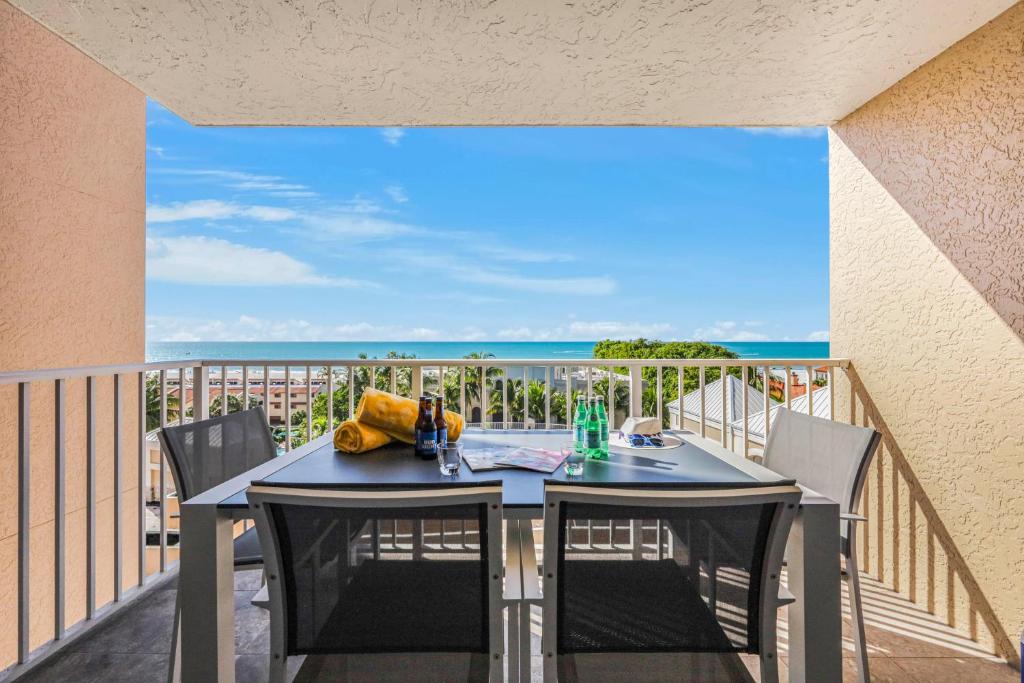 a table on a balcony with a view of the ocean at Marco Beach Ocean Resort 910 in Marco Island