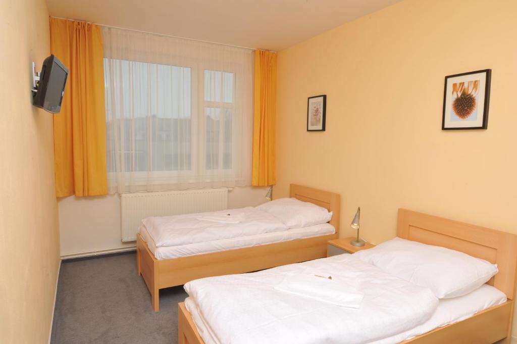 Postel nebo postele na pokoji v ubytování Pension Milk Inn