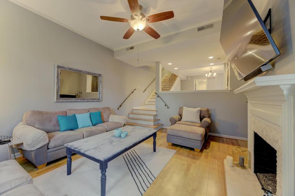 a living room with a couch and a fireplace at The Landing at Wheat St. 2Br in Columbia