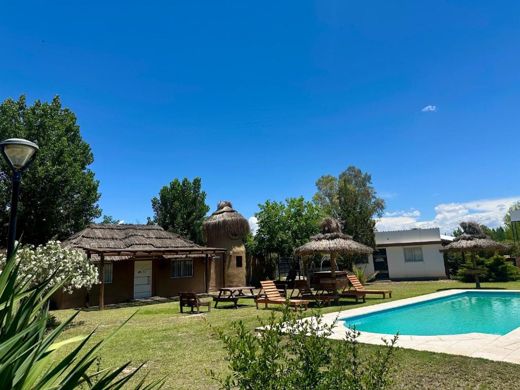 a villa with a swimming pool and a resort at Complejo de Cabaña con pileta CABLE A TIERRA Cabaña Blend in San Rafael