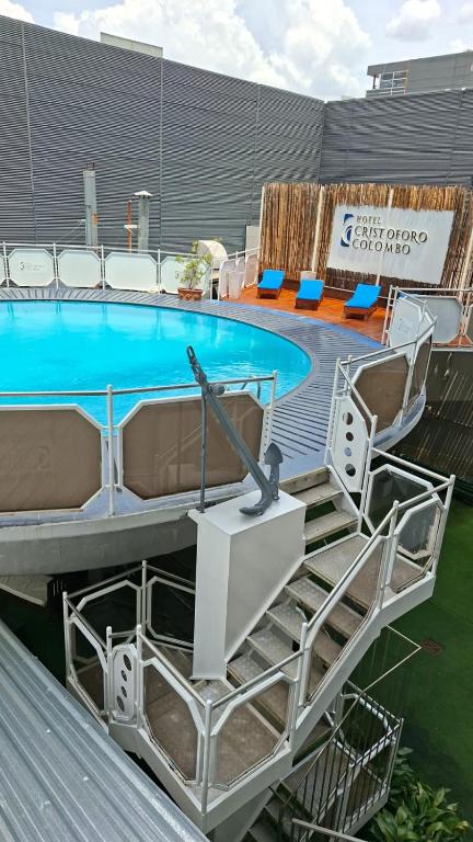 a swimming pool with stairs and a table and a pool at Hotel Cristoforo Colombo in Buenos Aires