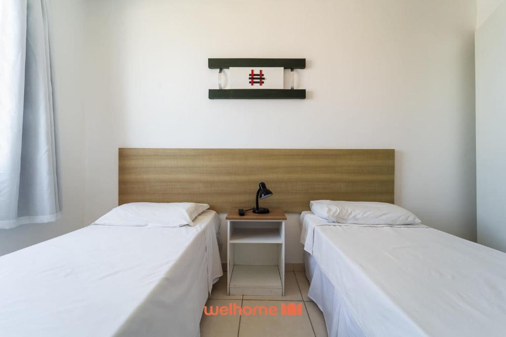 En eller flere senge i et værelse på Apartamento no Centro de Macae a Metros da Praia