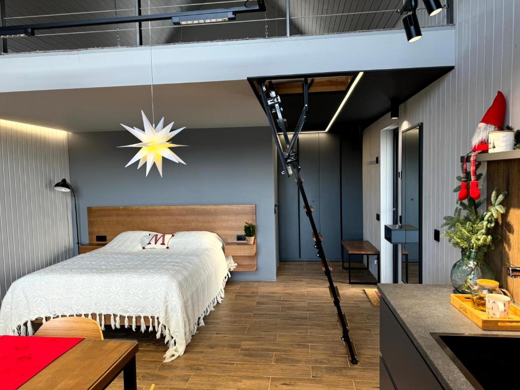 a room with a bed and a tripod at BarnHouse "Family Estate" in Kamianets-Podilskyi