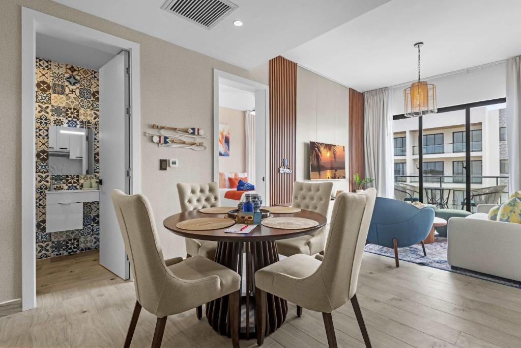a dining room and living room with a table and chairs at NOK Elegant 2BR Apt by Vistacana in Punta Cana