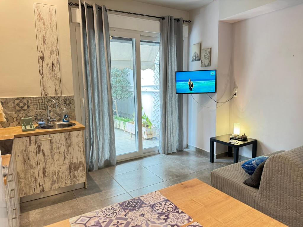 a living room with a couch and a tv at Seaside Escape in Athens