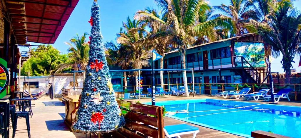a christmas tree in front of a swimming pool at Wild Rover Beach Mancora in Máncora