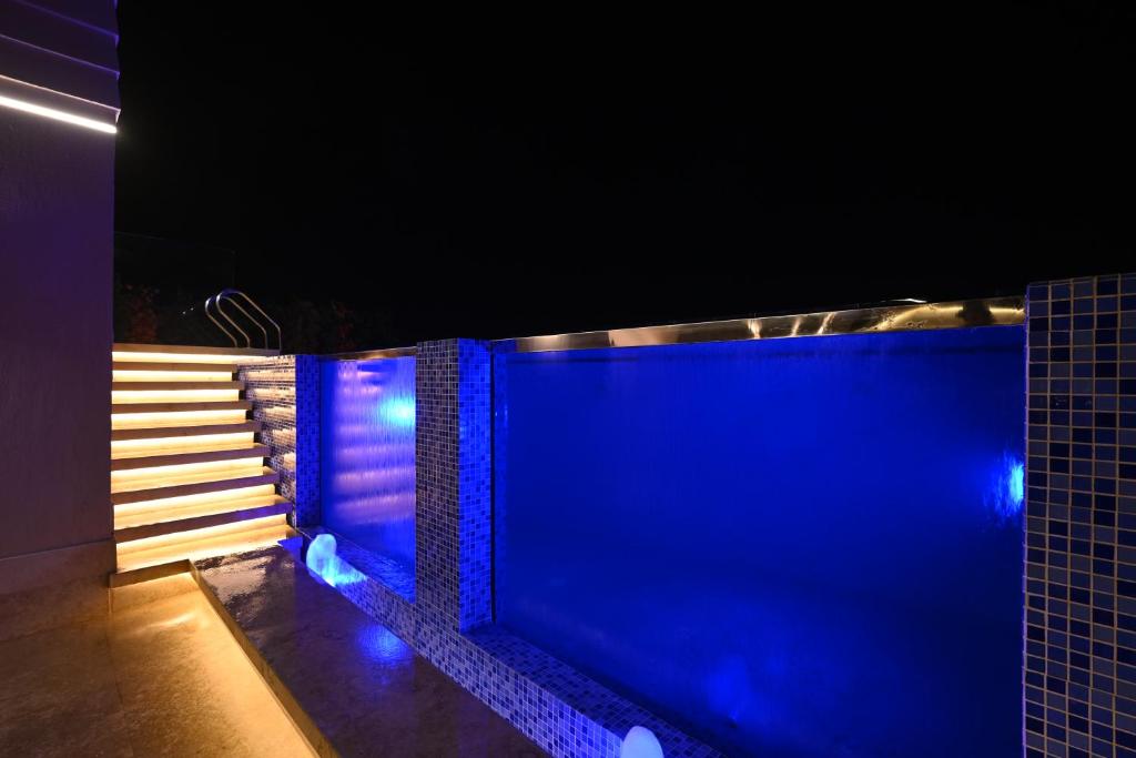 a swimming pool with blue lights on the side at Solana sky pool boutique hotel - Adults only in New cairo