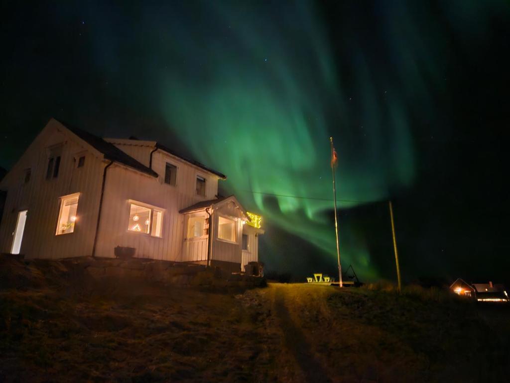 a house with the aurora in the sky at This Old House - Check in Breathe out in Strønstad