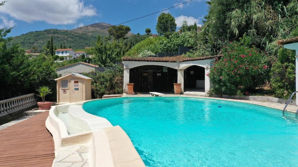una piscina en un patio con una casa en Villa provençale avec vue mer, piscine et CLIM, en Vence