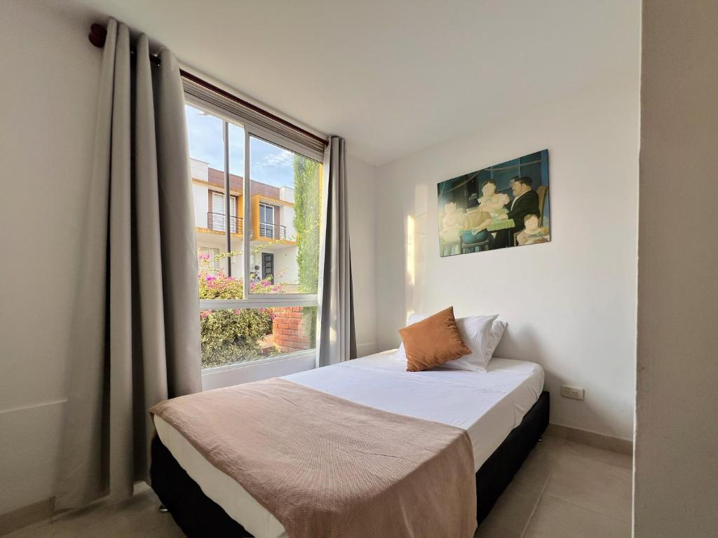 a bedroom with a bed and a large window at Casa campestre Curiti in Curití