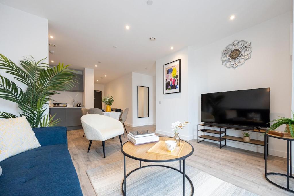 a living room with a couch and a tv at HighRise Heaven 2BR Manchester City Centre in Manchester