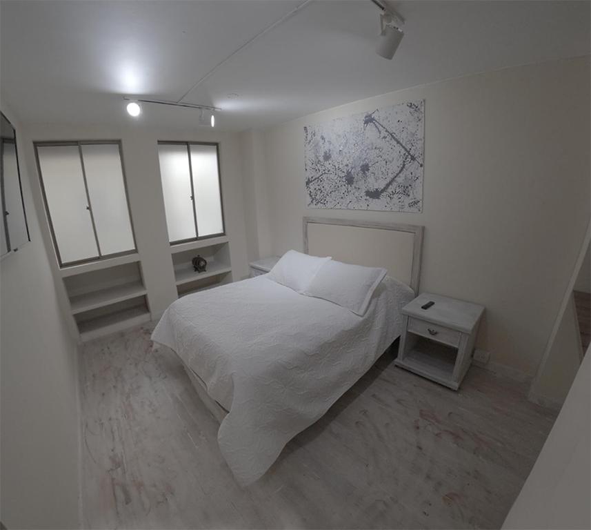 En eller flere senge i et værelse på Apartamento Manizales excelente ubicación