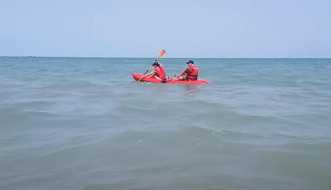two people in a red kayak in the ocean at Polaris, Cerca a la mejor playa con bandera azul in Coveñas