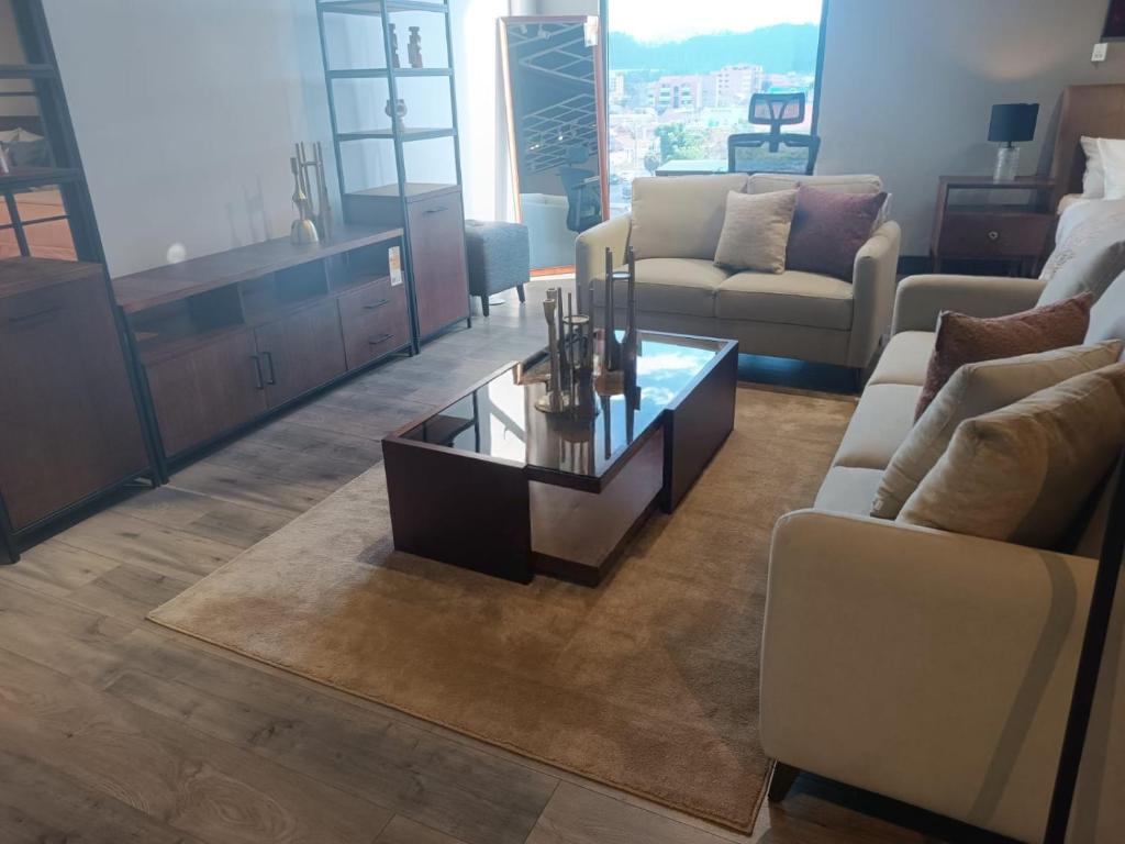 a living room with a couch and a coffee table at Departamento en Cuenca de tres habitaciones in Cuenca