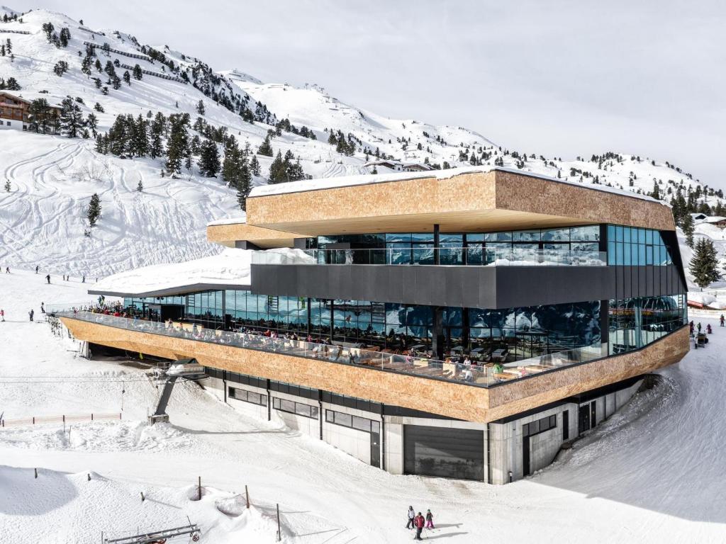a building on top of a snow covered mountain at Mountain View Loft Bergkristall in Kaltenbach