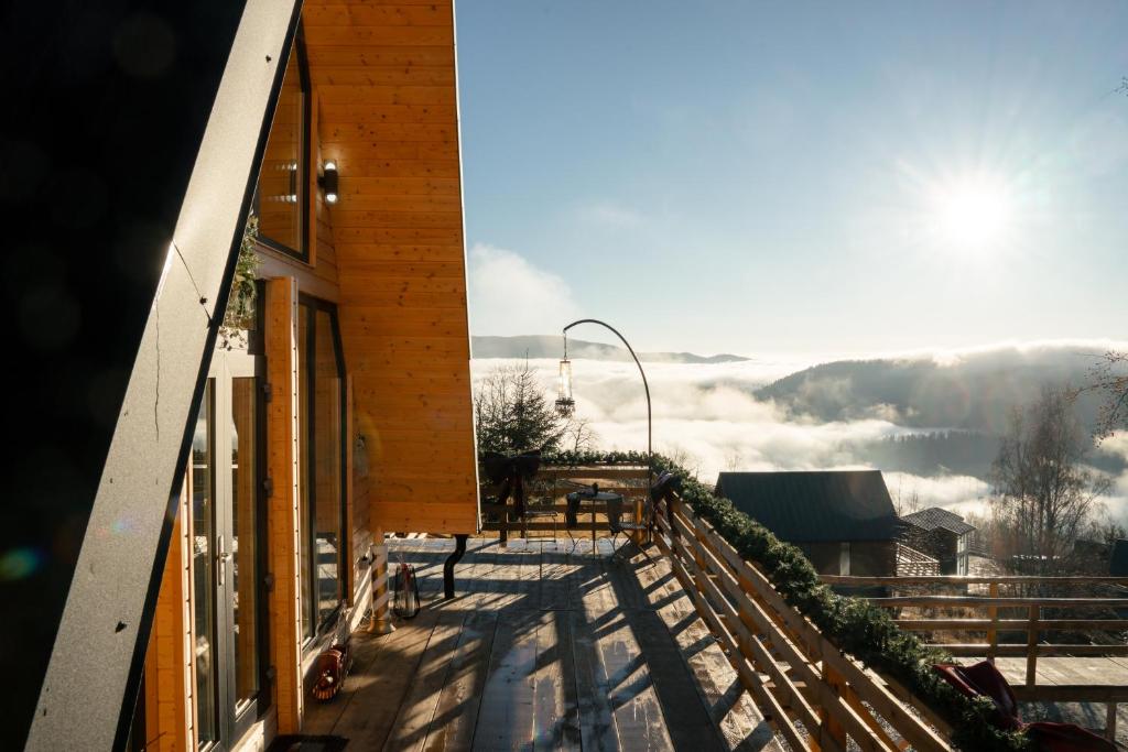a balcony of a building with a view of the mountains at Black Roof in Horea