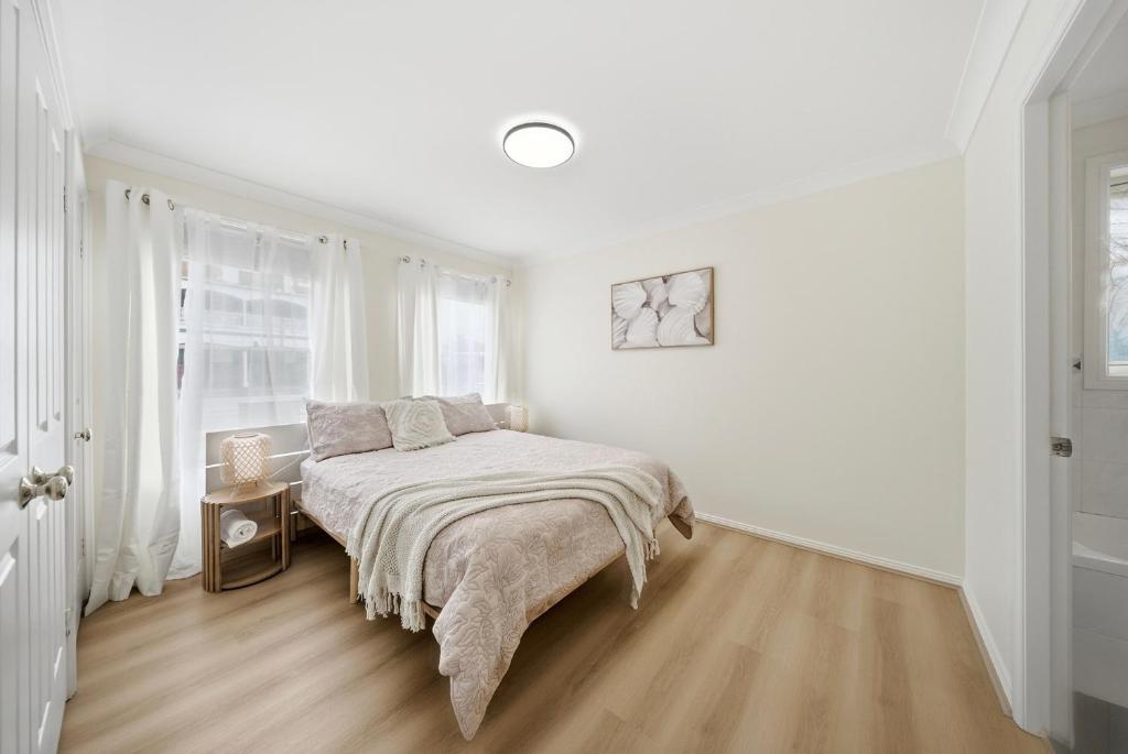 a white bedroom with a bed and a window at Bellbird Willow Hunter Escape by Nature & Winery in Bellbird