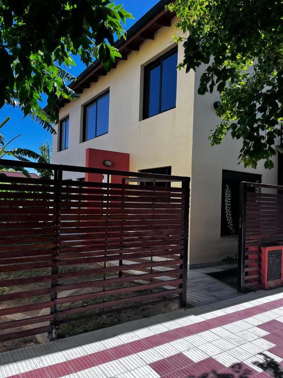 a house with a fence in front of it at Shakti in Almafuerte