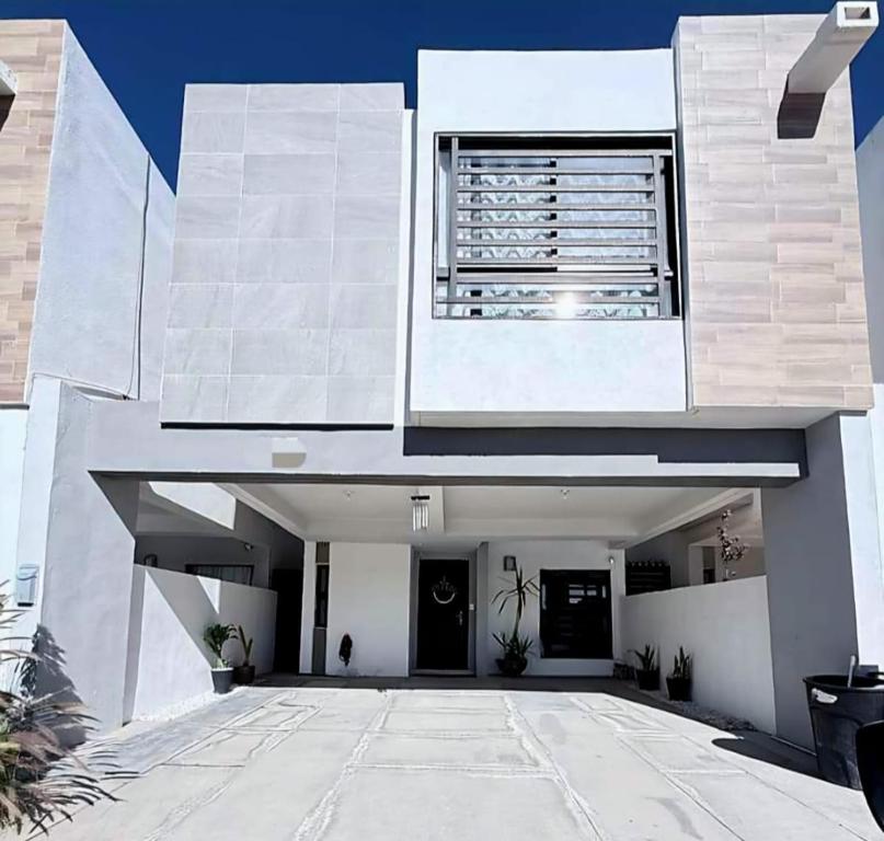 a large white building with a window on top at Casona Álamo in La Coyotera