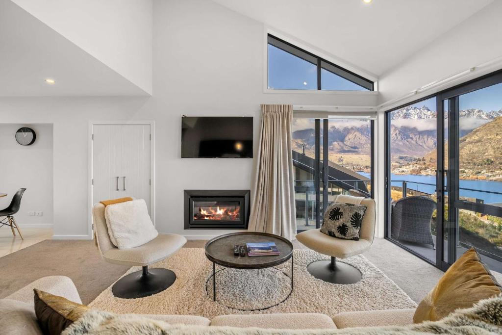 a living room with a couch and a fireplace at Bluewater Views in Queenstown