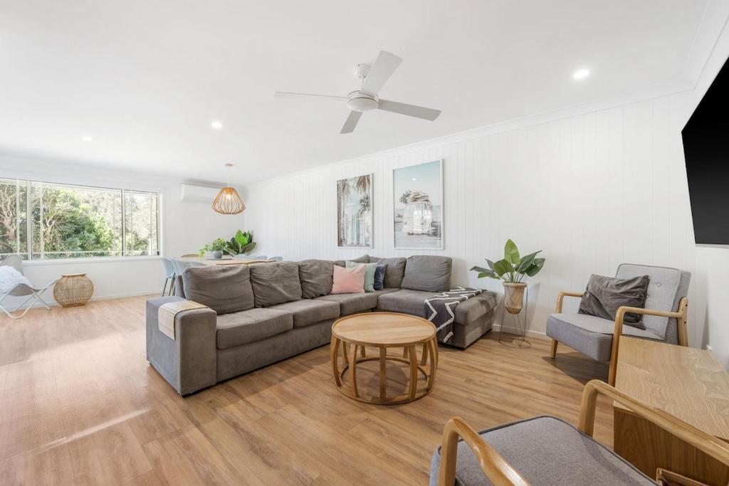a living room with a couch and a table at Spades - at Lighthouse Beach in Port Macquarie