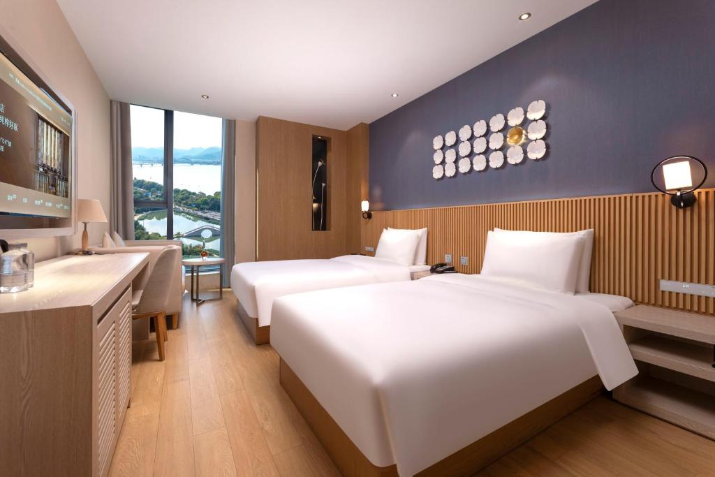 Postel nebo postele na pokoji v ubytování Crystal Orange Hotel (Hangzhou Binjiang Star Avenue)