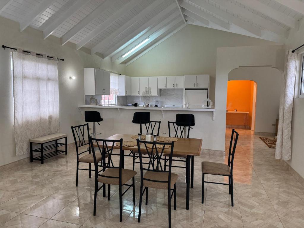 a dining room and kitchen with a table and chairs at Spacious Home 5 Min from Crane Beach Resort in Saint Philip